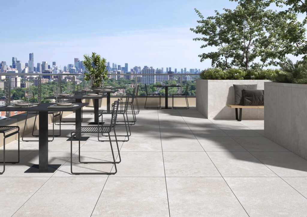 Travertine-look porcelain pavers on an outdoor terrace
